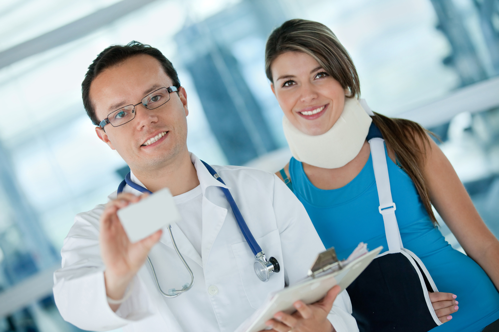 Doctor with a woman displaying an insurance card